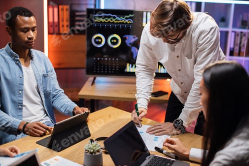 Preview: Team of multi ethnic brokers examining financial situation