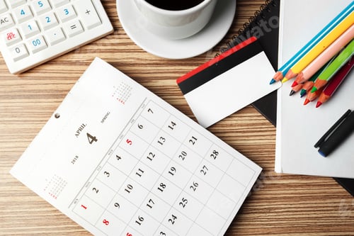 Preview: Work desk setup with calendar, coffee, and colorful stationery during April