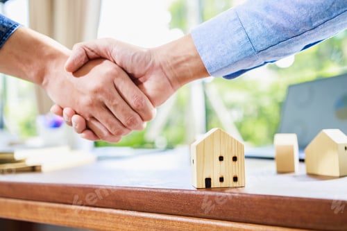 Preview: Successful agreement, estate, home buying contract. Focus at home model and handshake in background