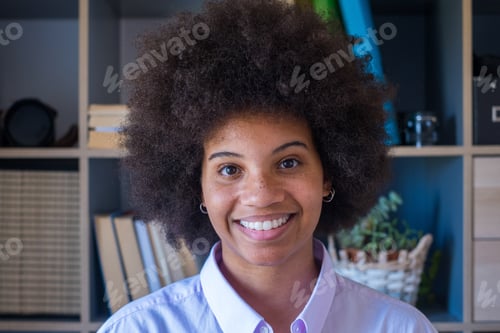 Preview: Close-up portrait of attractive dark skinned young woman with curly Afro hairstyle.