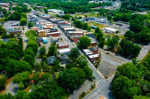 Preview: Drone shot of trees and small rural houses in the town of Elkin, North Carolina on spring day