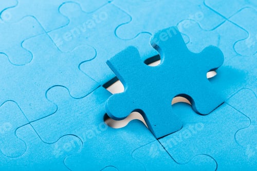 Preview: Colorful blue puzzle piece fitting into an empty spot on a blue puzzle board