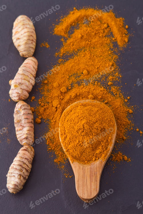 Preview: turmeric powder and roots on wooden background
