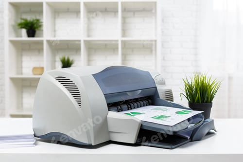 Preview: Printer in an office printing documents with green graphics and a plant nearby