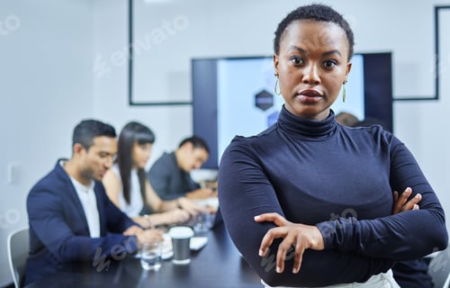 Preview: Portrait of a young businesswoman standing in an office with her colleagues in the background