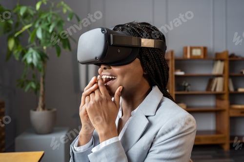 Preview: Impressed african american businesswoman feeling excited while testing vr headset in office