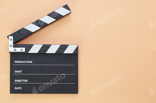 Preview: black cinema clapperboard on orange background with free space for text