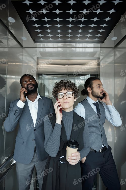 Preview: Group of three young intercultural office managers with smartphones