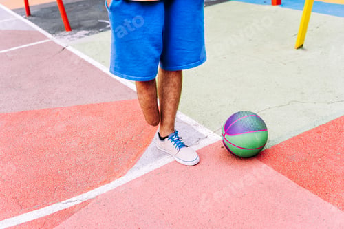 Preview: amputated young boy playing basketball at the park