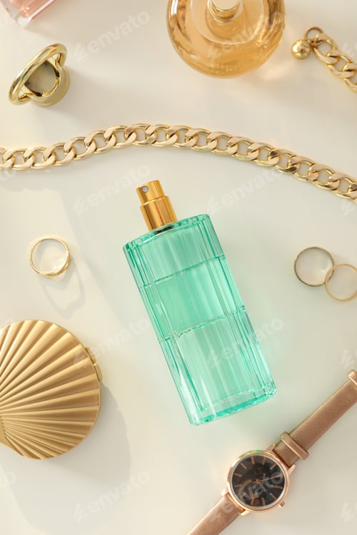 Preview: A bottle of perfume on a table with gold ornaments