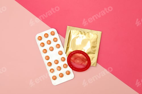 Preview: Condoms and pills on two tone background