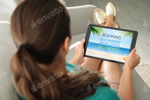 Preview: Young woman using tablet to plan trip indoors, closeup. Travel agency concept
