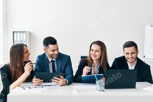 Preview: Smiling Professionals Working Together at Conference Table
