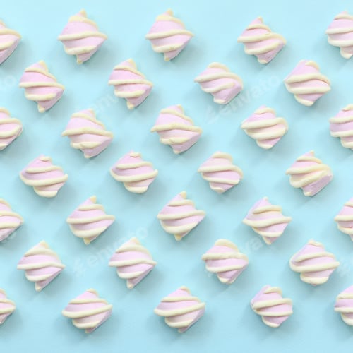 Preview: Colorful marshmallow laid out on blue paper background. pastel creative textured pattern. minimal