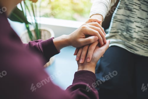 Preview: A man and a woman holding each other hands for comfort and love