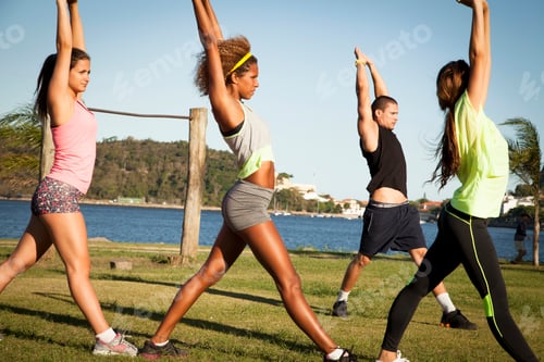 Preview: Three young women stretch training in park