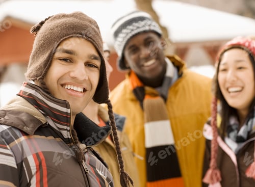 Preview: Three young people, two men and a woman in hats and scarves.