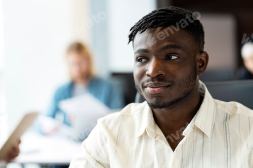 Preview: African American professional contemplating future career opportunities in busy office, copy space
