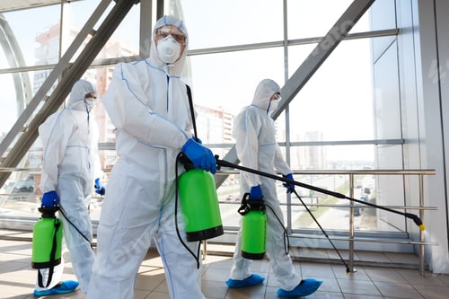 Preview: Professional workers in hazmat suits disinfecting indoor accommodation