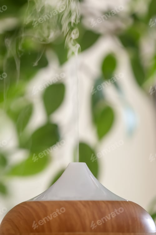 Preview: Aroma oil diffuser lamp on blurred background, closeup