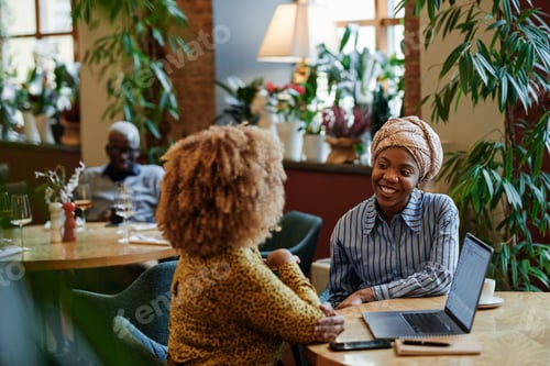 Preview: Business people sitting at meeting in cafe