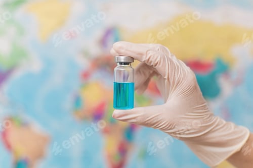 Preview: Doctor holds an ampoule with a vaccine on the background of the world map. World vaccination concept