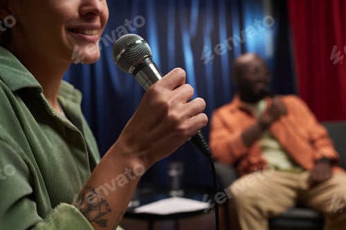 Preview: Smiling Woman Holding Microphone During Discussion Event