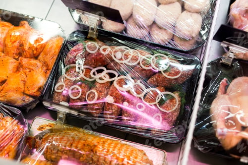 Preview: Meats in marinade on supermarket display, pre-cooked food