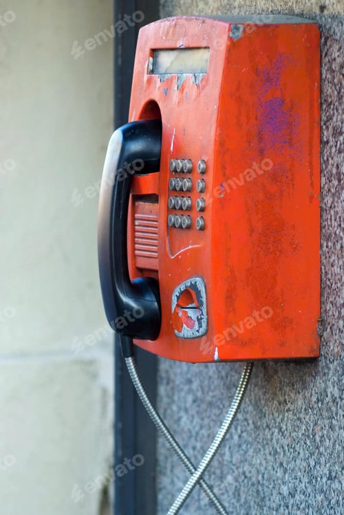 Preview: The Big Old Payphone Of Red Color A Closeup And Located Outdoor On A Wall