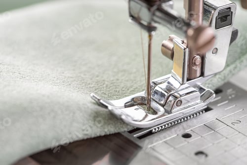 Preview: Modern Sewing Machine Presser Foot With Green Fabric And Thread, Closeup, Macro
