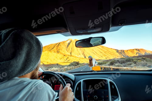 Preview: Young hitchhiker on the road and man driving