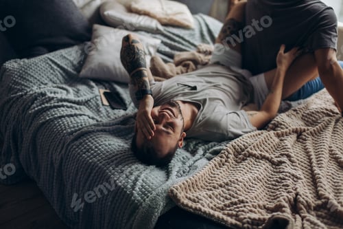 Preview: Two sexy caucasian gay guys hugging and having fun in bed indoors