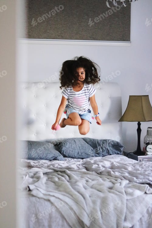 Preview: Little girl is jumping on the bed