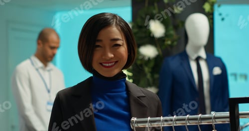 Preview: Stylish woman explores clothing options in a modern boutique