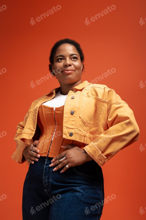 Preview: Stylish autumn outfit showcases body positivity in a vibrant studio setting