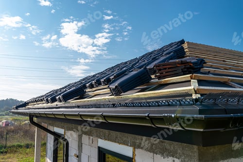 Preview: Roof ceramic tile arranged in packets on the roof on roof battens. Preparation for laying roof tiles