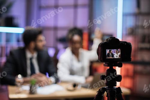 Preview: View from screen of camera with male and female financiers