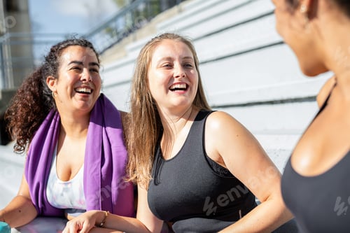 Preview: Young women smiling at each other in sportswear. Running and doing sports with friends.