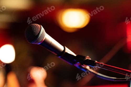 Preview: Close-up shot of a microphone in a blurry bar setting.