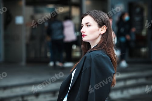 Preview: Elegant Woman in City Setting with Serious Expression