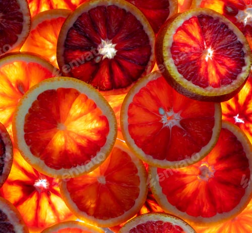 Preview: Red oranges fruit background. Sliced juicy orange. Food. Summer concept. Close-up on the light.