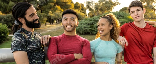 Preview: Group of four multiracial runners smiling looking at the camera. Focus on the Asian man