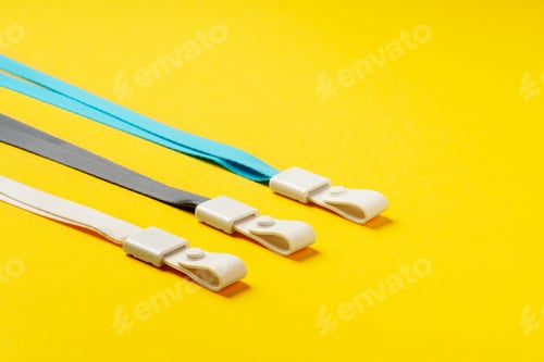 Preview: Badge strings on yellow background close up