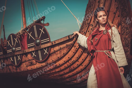 Preview: Viking woman in traditional clothes near drakkar