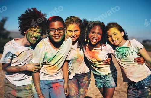 Preview: Shot of a group of teenagers having fun with colourful powder at summer camp