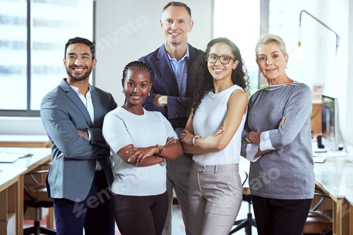 Preview: Theyre all about their business. Shot of a group of businesspeople standing in an office at work.