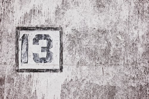 Preview: Friday 13th background, number thirteen on dirty stone wall