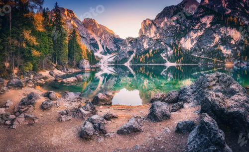 Preview: Stones on the coast of Braies lake at sunrise in autumn