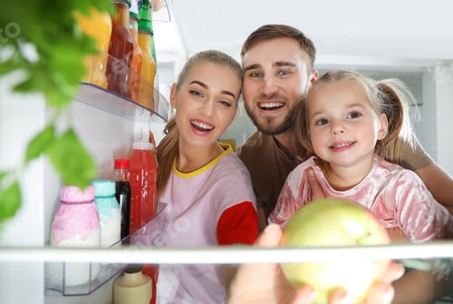 Preview: Happy family looking into refrigerator and choosing products in kitchen