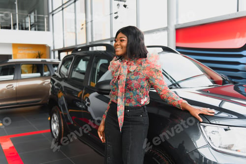 Preview: Woman buying the car. Lady in a car salon. Elegant black girl